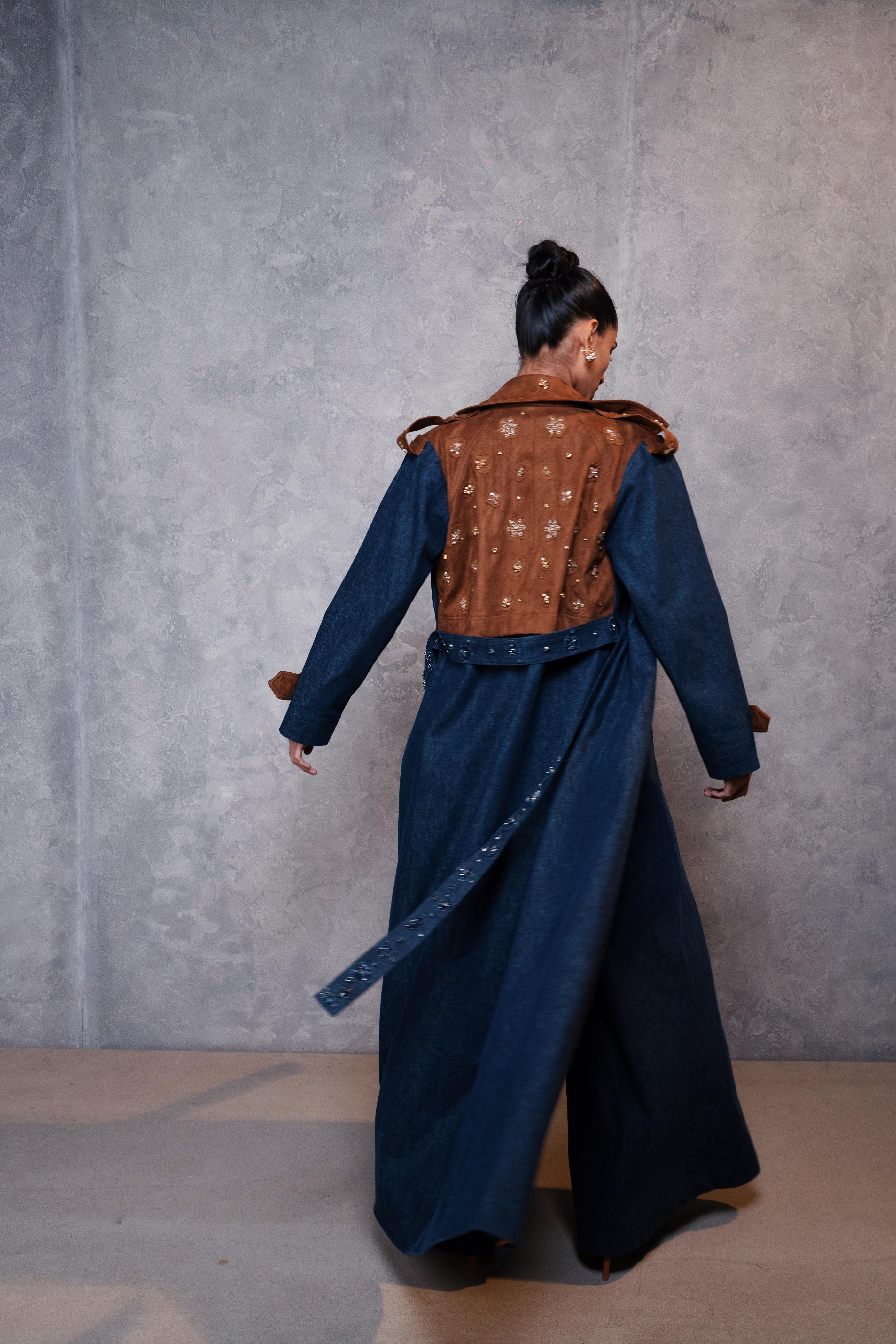 Person wearing a blue dress with a brown patterned top