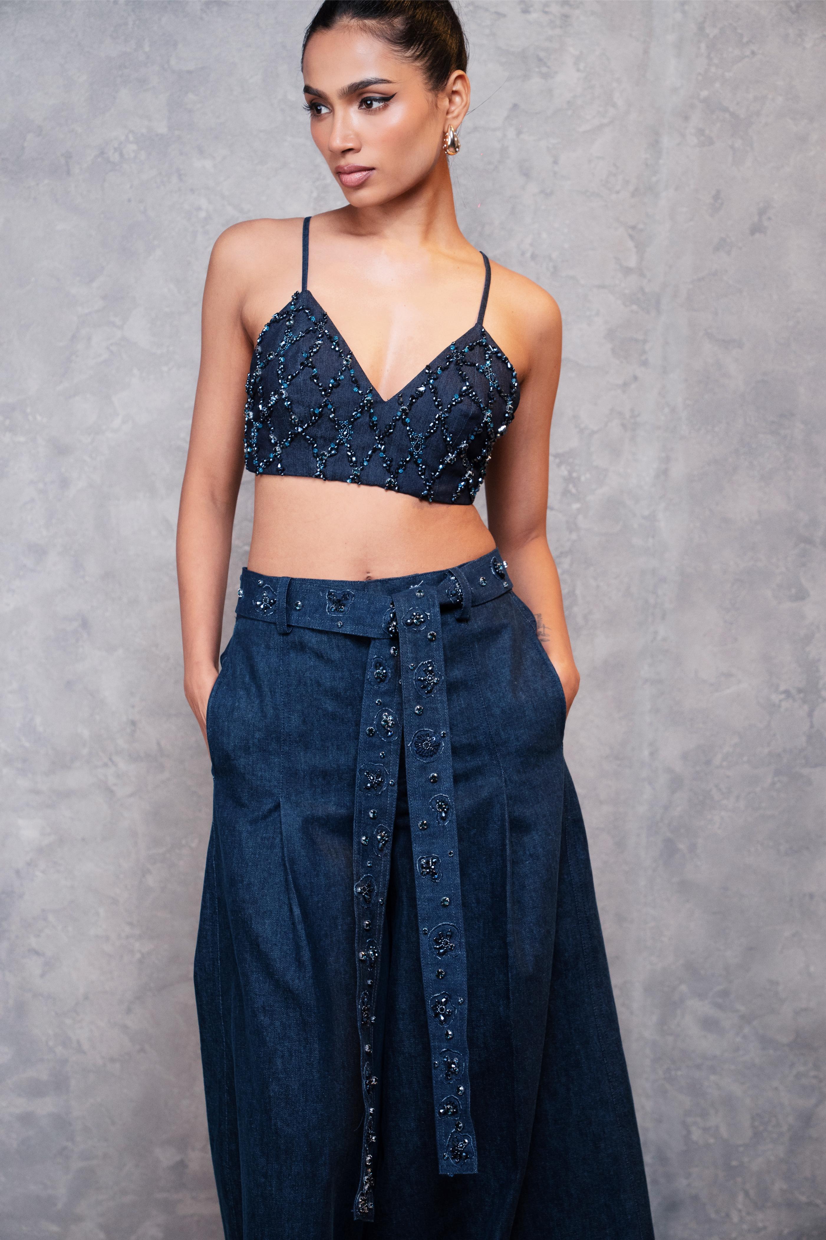 Woman wearing a dark blue beaded top and matching pants