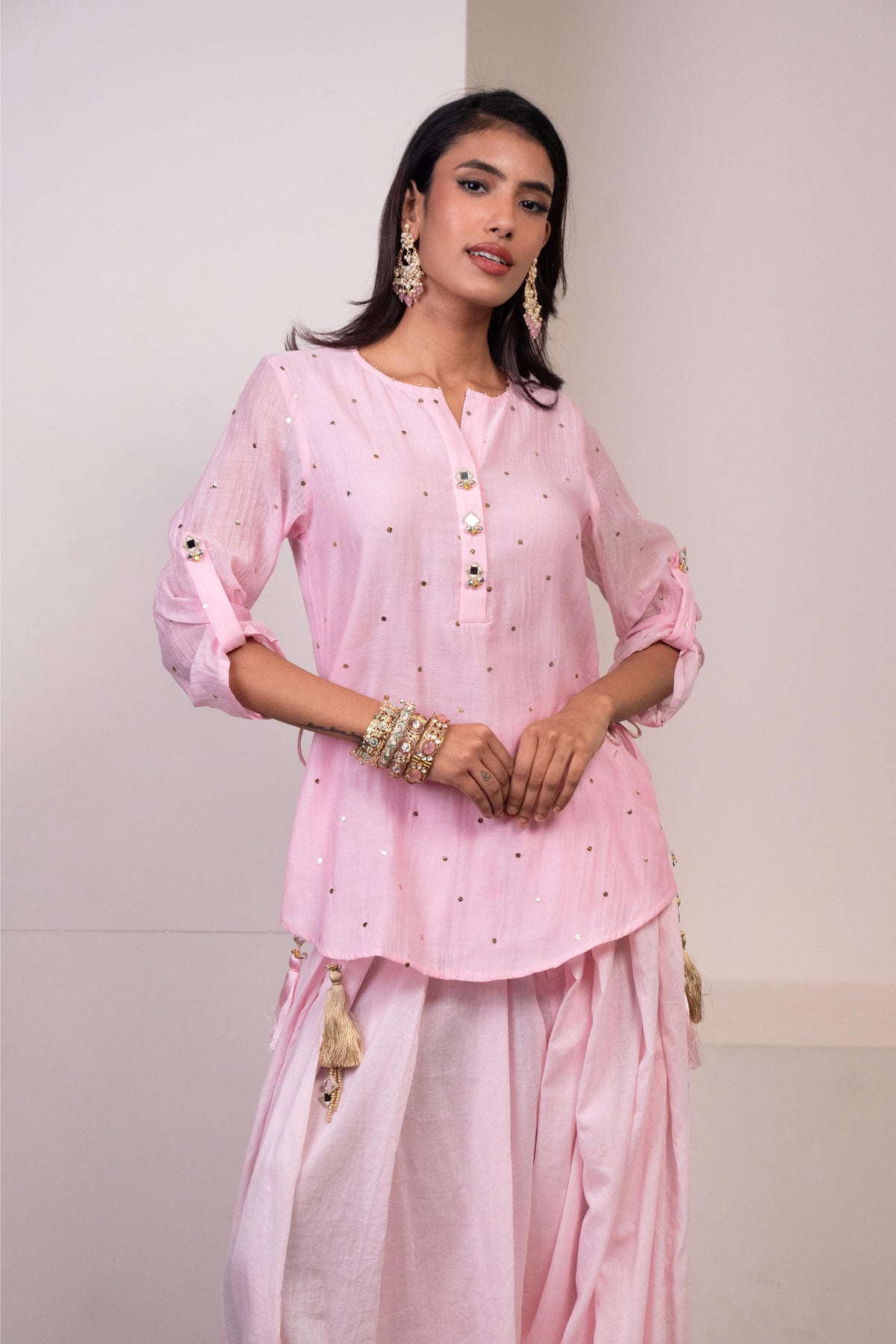 Woman wearing a pink traditional outfit with white polka dots