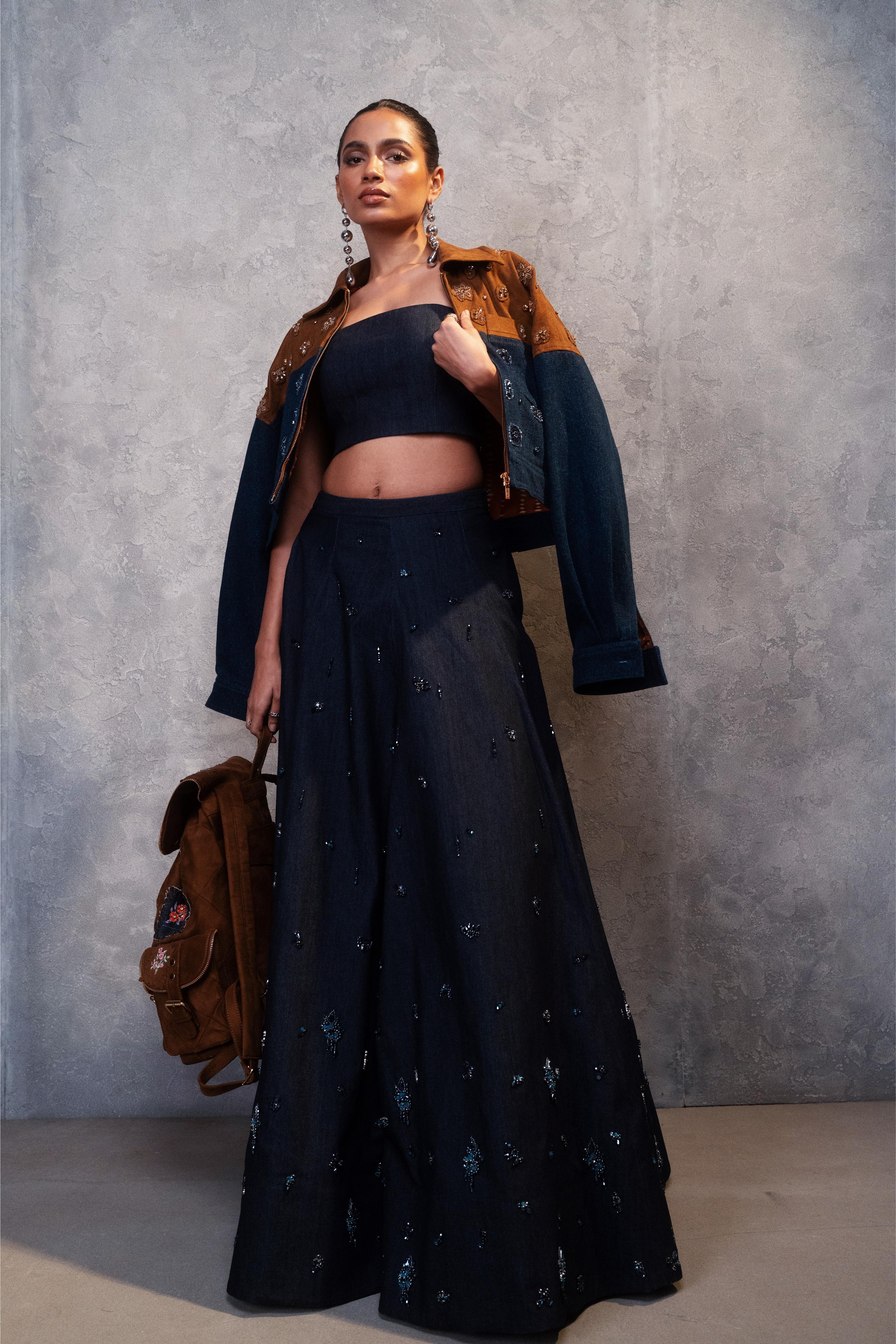 Woman in a black outfit with a brown jacket