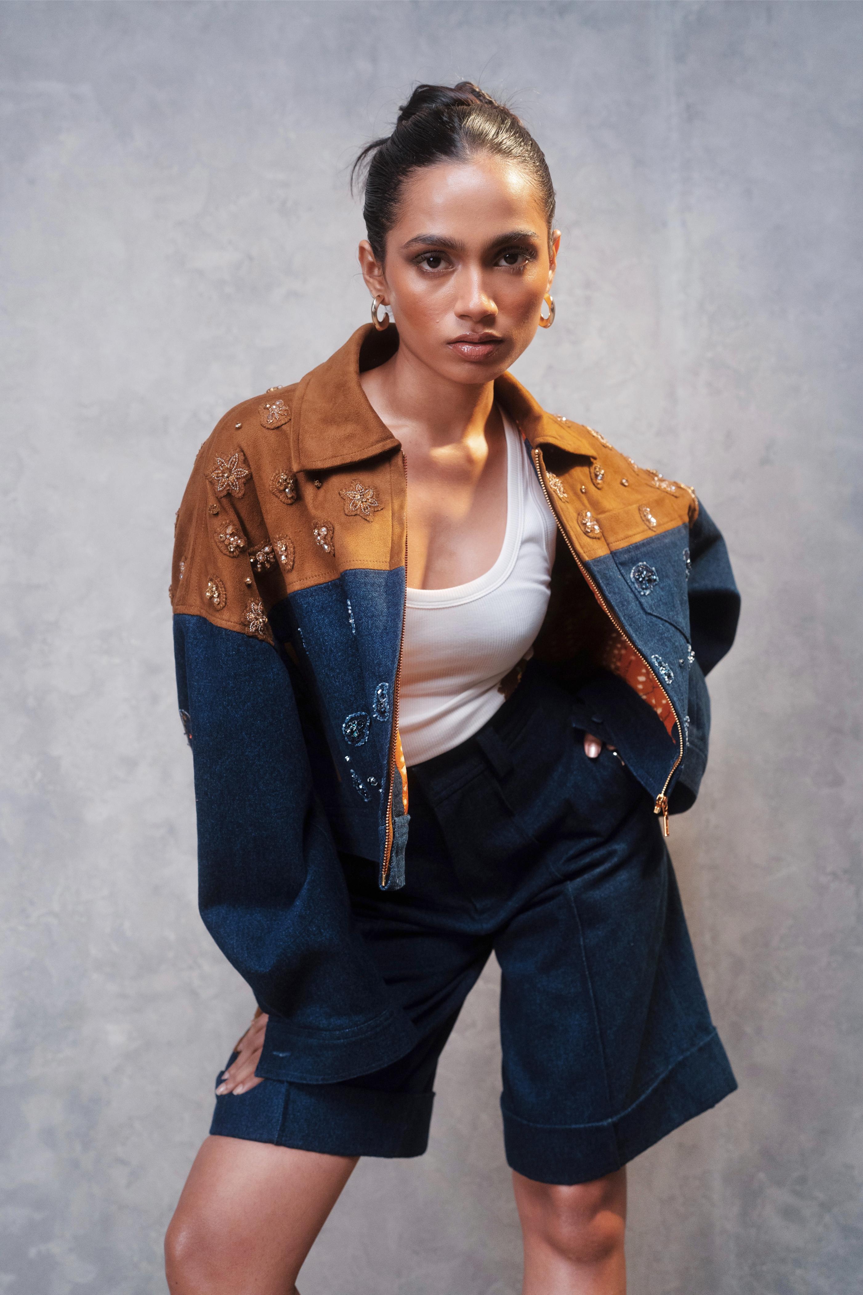 Woman wearing a patchwork jacket and shorts